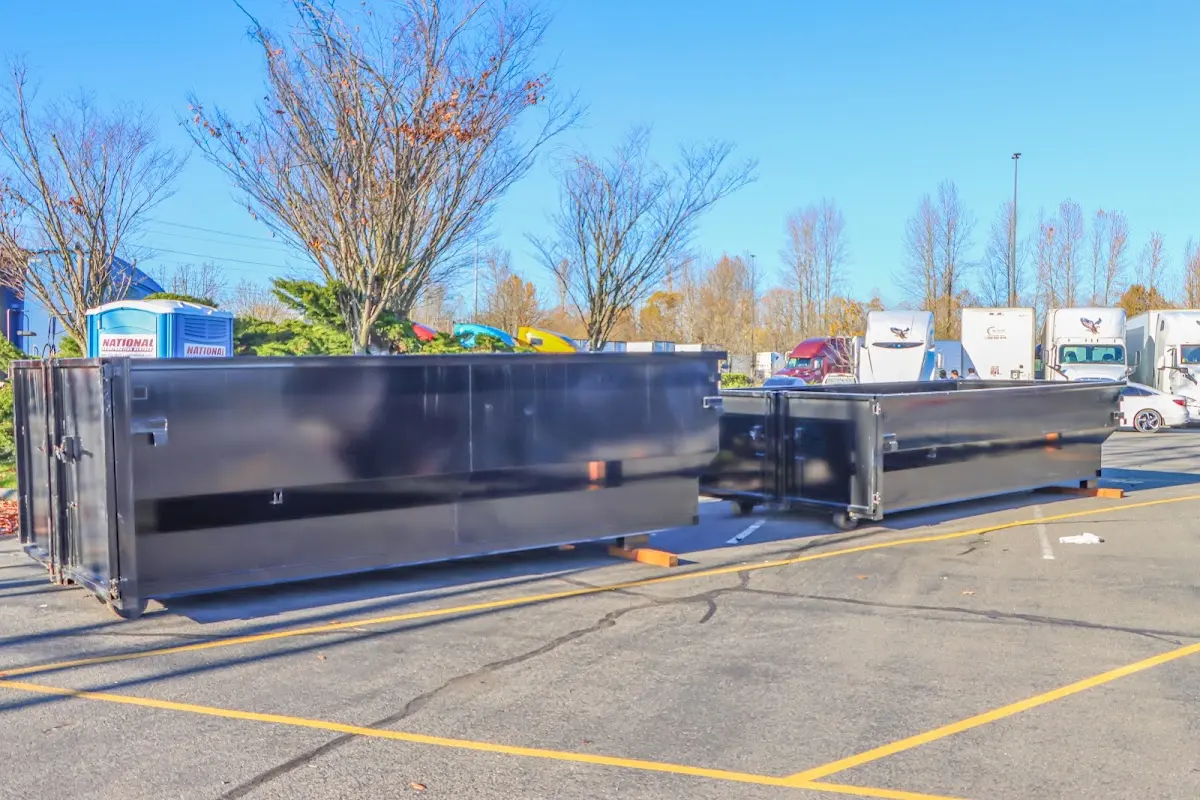 Professional dumpster rental service with roll-off container on residential driveway in Greenbrier